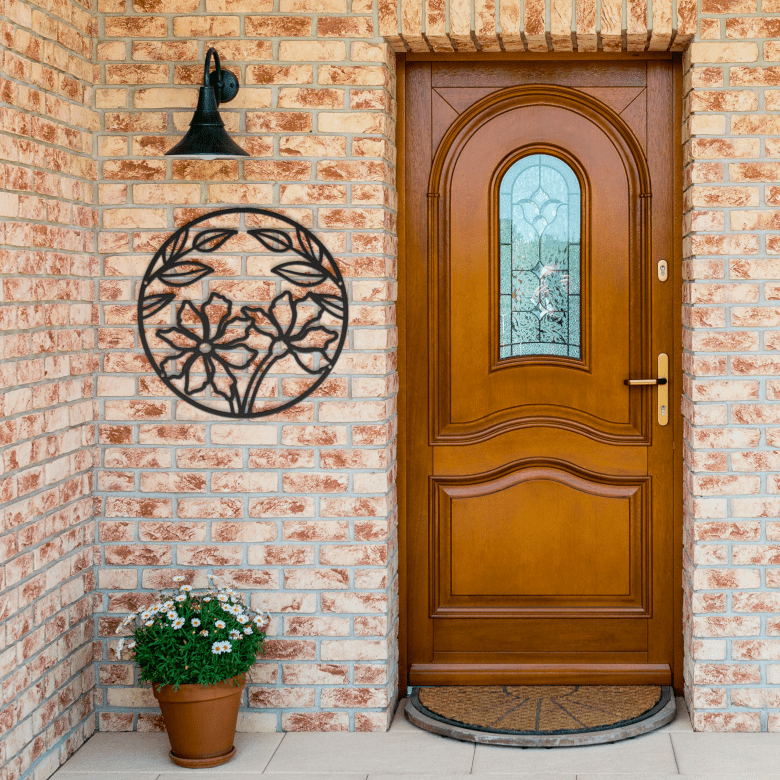 Bold black full moon floral wall sculpture on brick entrance wall, ideal for sacred space vibes