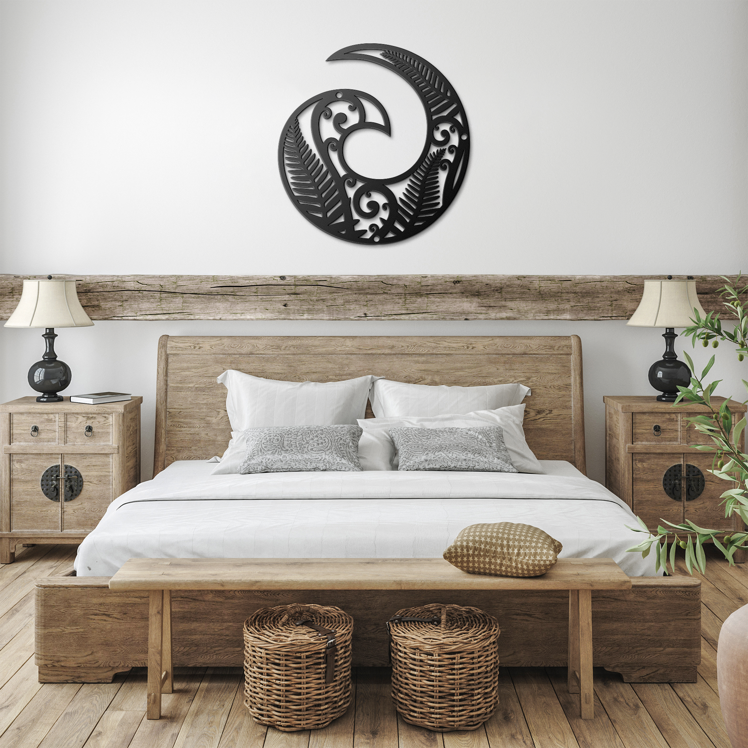 Black Koru metal wall art hanging on a light-colored wall above a wooden bench with green plants, creating a serene, spiritual space.
