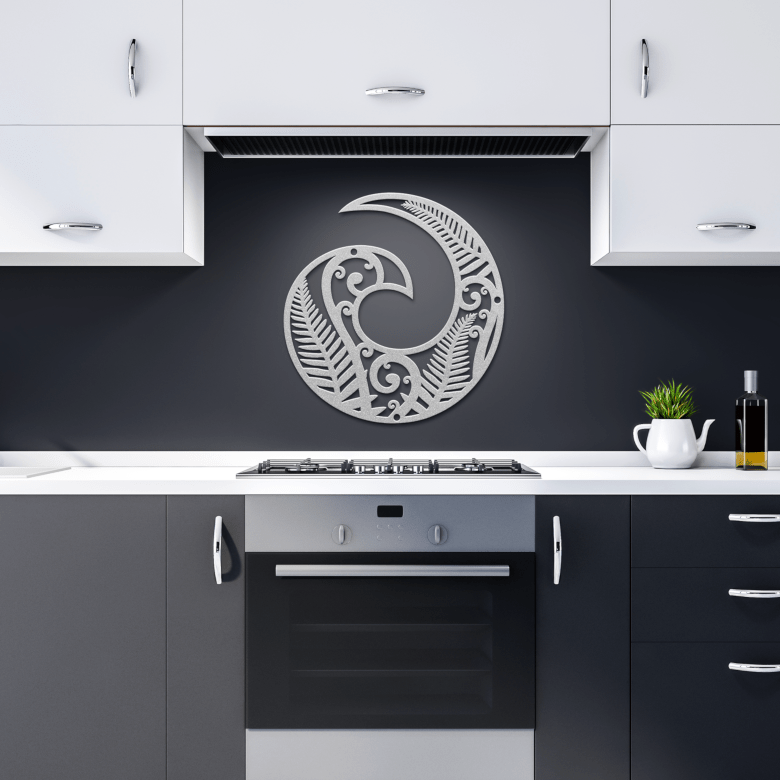 Silver Koru symbol decor in modern dark kitchen setting