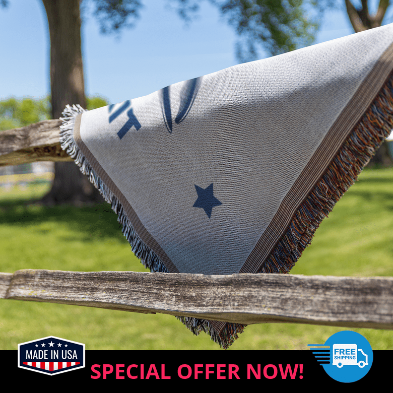 Blue whale blanket draped over rustic fence, showcasing ocean-inspired comfort and durability
