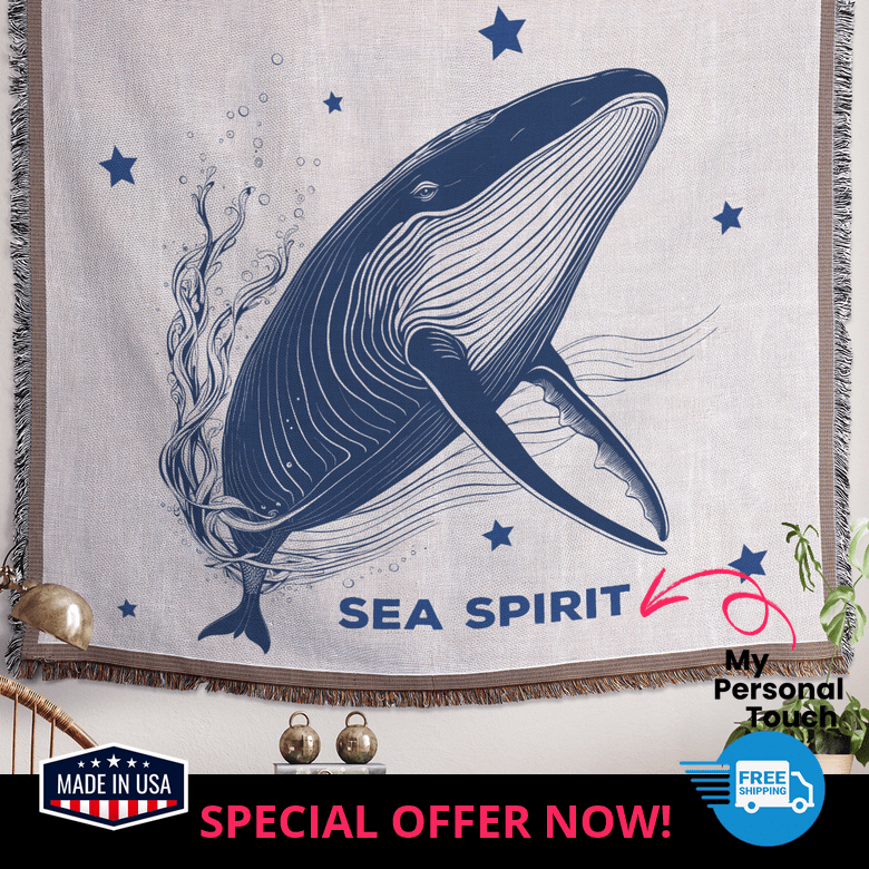 Personalized whale and stars blanket hanging as wall art in a calming coastal room