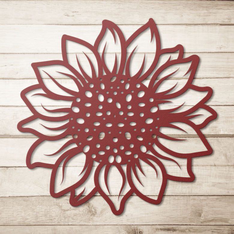 Rustic red sunflower metal wall art showcased against a light wood background, highlighting the handcrafted detail and uplifting symbolism of the design.