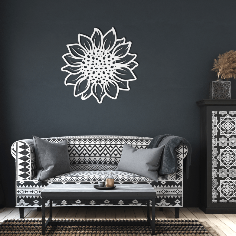 Sunflower metal wall art in white finish displayed in a dark-toned living room, adding a fresh and radiant focal point above a minimalist sofa setup.