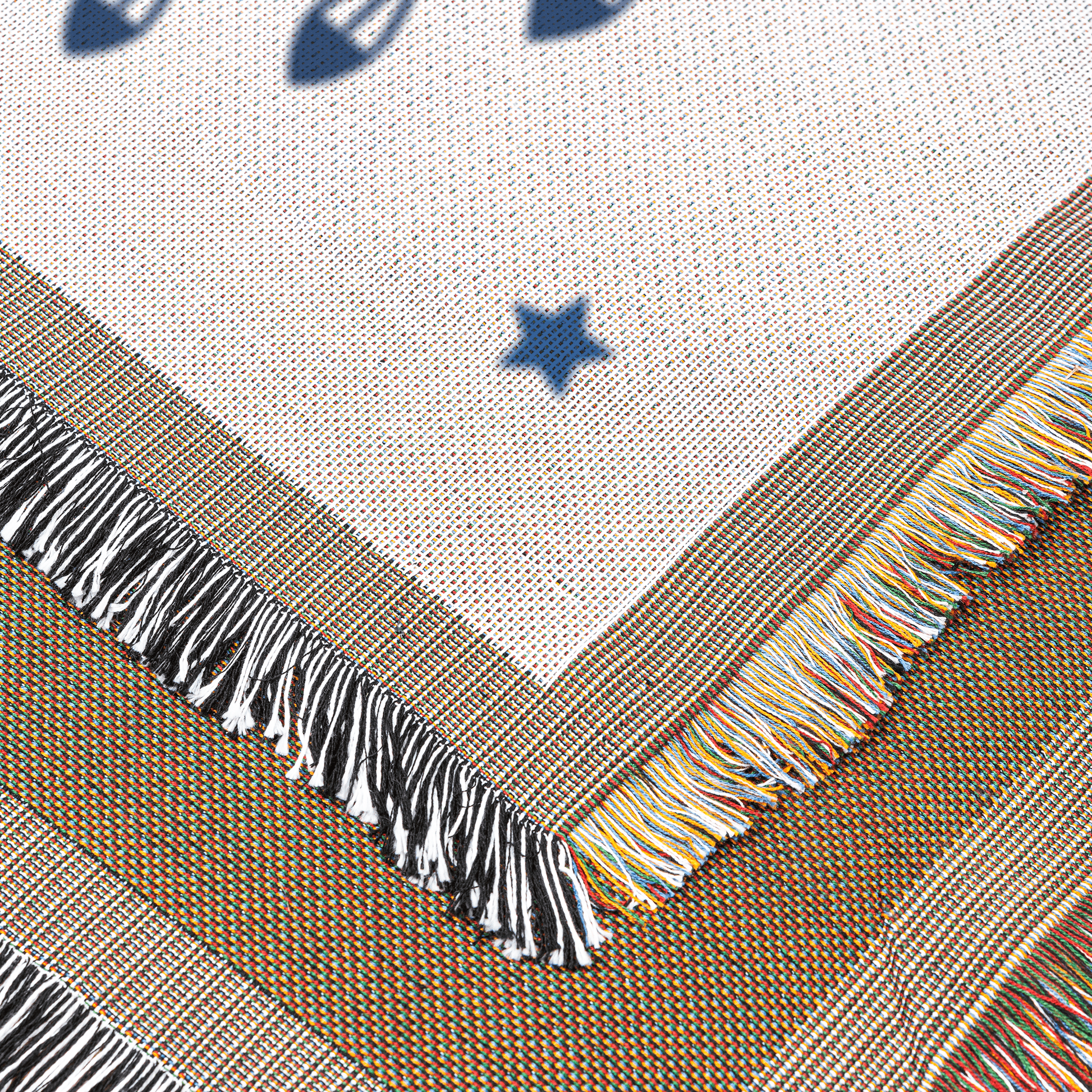 Textile with star pattern and colorful fringe on a neutral background