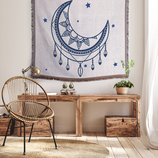 Mystical Moon Woven Blanket hung as a large tapestry, celestial moon and star design for meditation spaces and bedrooms.